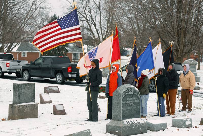 The Venturing Crew 413 Color Guard presents the flags at St. Gall’s Cemetery in Elburn on Saturday, Dec. 17, 2022.
