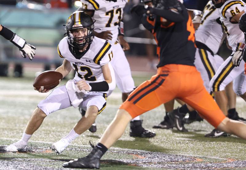 Metea Valley quarterback Lucas Van Vlerah tries to put a move on DeKalb's Nathan Smith during their game Friday, Sept. 16, 2022, at DeKalb High School.
