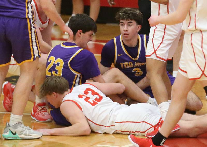 Mendota's Dane Doyle and teammate Cam Kelly dive on a loose ball with Ottawa's Owen Sanders on Tuesday, Jan. 7, 2025 in Kingman Gym at Ottawa HIgh School.