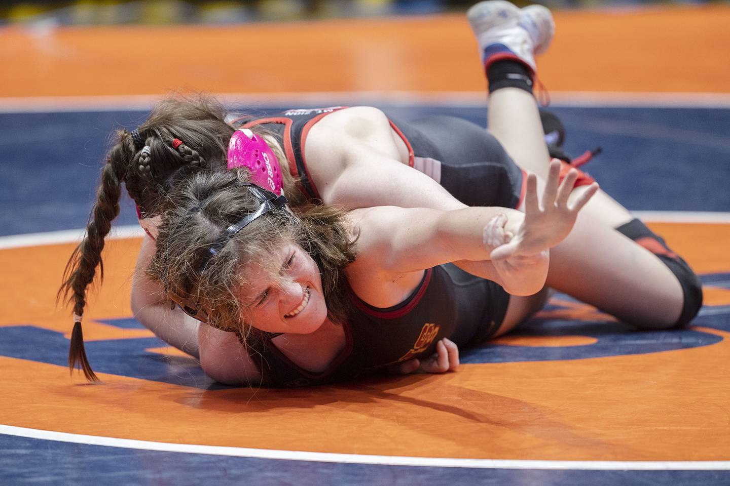 Morris’ Ella McDonnell reaches out while wrestling Mt. Zion’s Sydney Cannon during the 110-pound third-place match at the IHSA Girls Wrestling State Finals on Saturday, Feb. 25, 2023, in Bloomington.