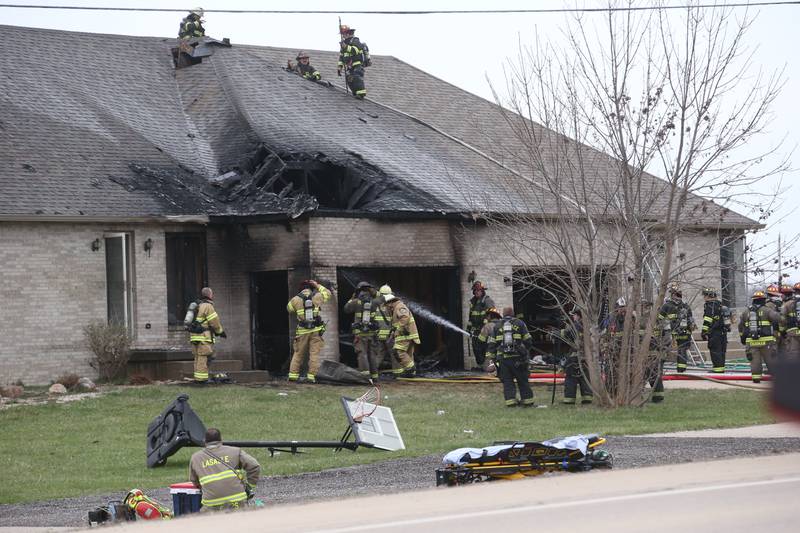 Firefighters work the scene of a structure fire in the 600 block of U.S. Route 6 on Tuesday, April 1, 2025 in La Salle. Fire departments from Peru, La Salle, Utica, Troy Grove, Wallace, Spring Valley and Oglesby were dispatched just before 2:30 to a one-story duplex home.