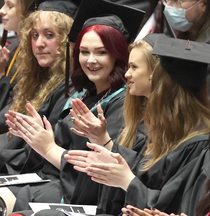 Graduation candidates applaud speakers in the Convocation Center Saturday, May 14, 2022, during the first of two undergraduate commencement ceremonies at Northern Illinois University in DeKalb.