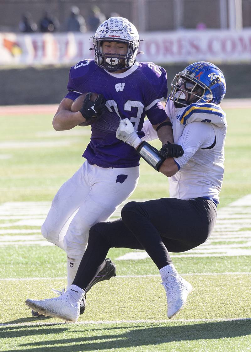 Wilmington's Hunter Kaitschuck is hauled down by Maroa-Forsyth's Troy Pulliam Friday, Nov. 28, 2025, in the Class 2A football finals at Hancock Stadium at ISU.