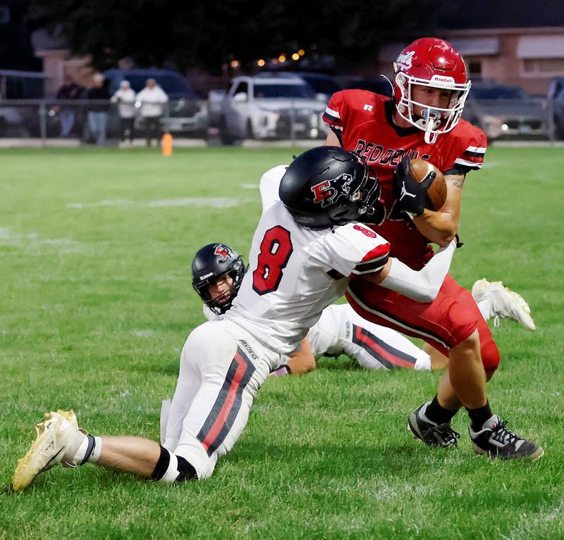 Panther Grayden Church forces #34 Red Devils running back Aiden Radcliff out of bounds in Hall Friday night.  Erie Prophetstown picked up their 2nd win of the season, beating Hall 19-7