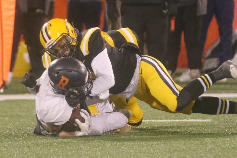 Rochester's Henry Buecker is taken down by St. Laurence's Joe Battung during the Class 4A State football championship on Friday, Nov, 24, 2023 at Hancock Stadium in Normal.