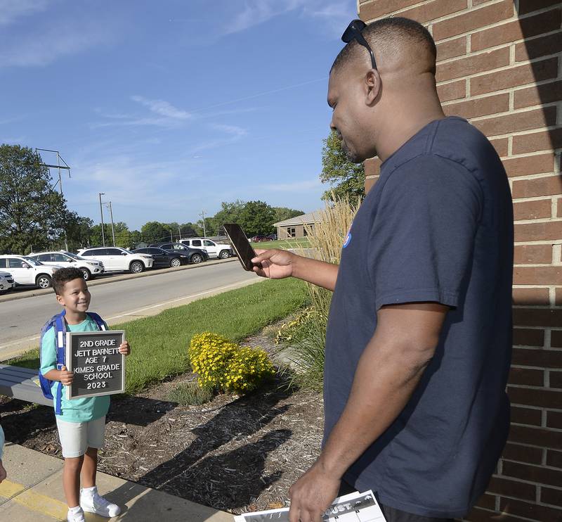Jeremy Barnett takes a photo of his son Jett as he gets ready to start the first day of classes Wednesday, Aug. 16, 2023, at Kimes School in Streator.