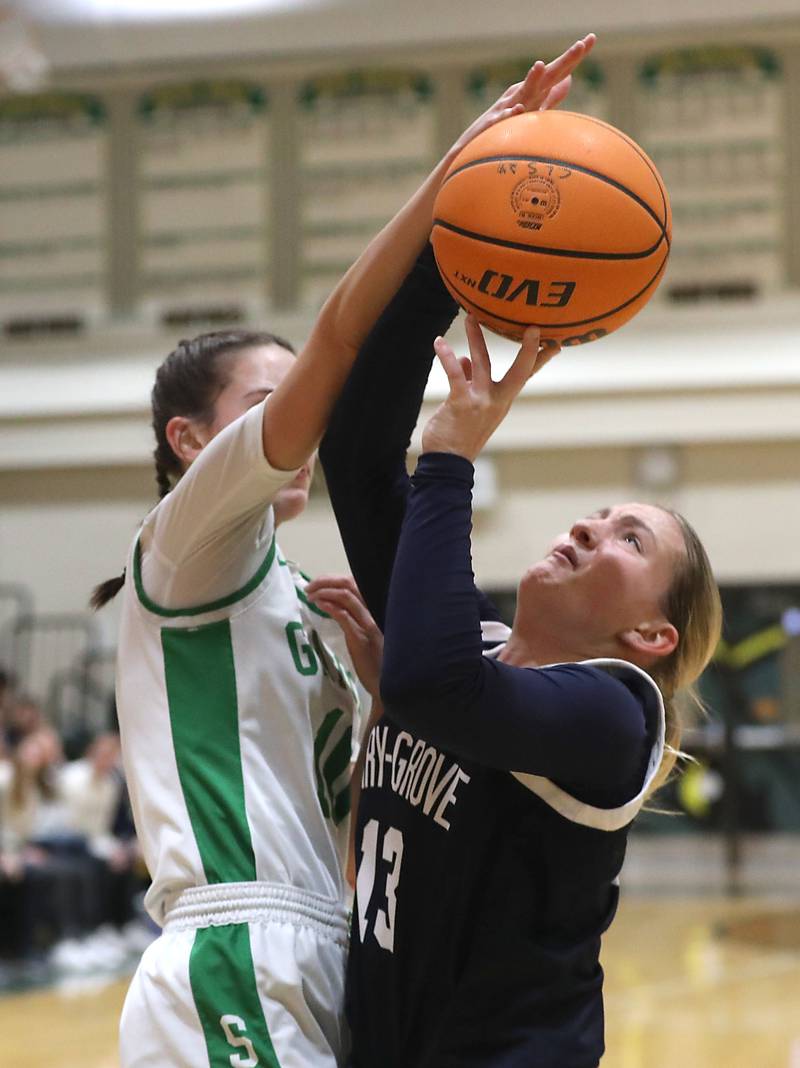 Cary-Grove's Malaina Kurth is fouled by Crystal Lake South's Mallory Glover as she takes a shot during a Fox Valley Conference girls basketball game on Friday, Jan. 23, 2026, at Crystal Lake South High School.