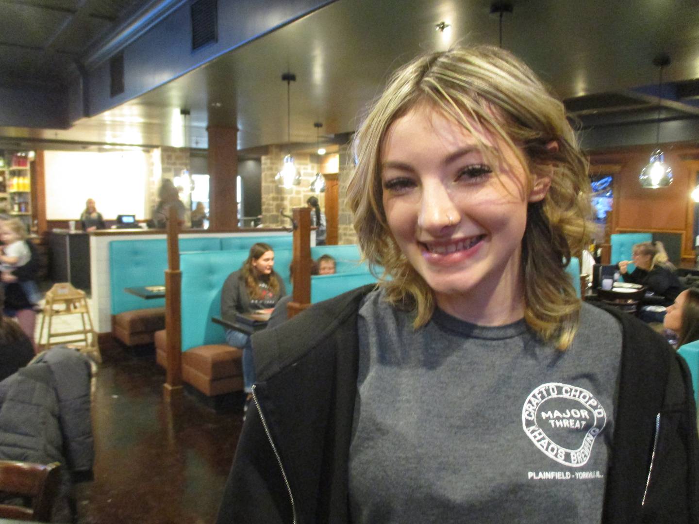 Bella Calabrese of Montgomery is a server at the new Craft'd restaurant in Yorkville. She is seen here in one of the large dining areas on opening day, Dec. 27, 2022.