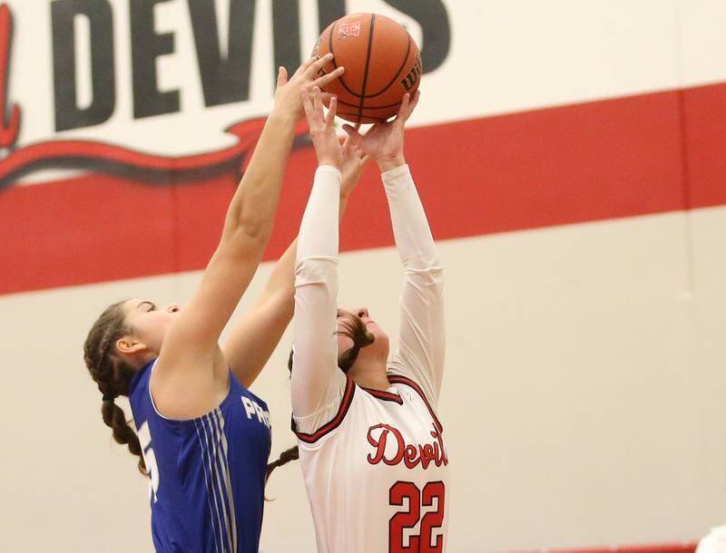 Hall's Kennedy Wozniak grabs a rebound over Princeton's Olivia Mattingly on Thursday, Nov. 30, 2023 at Hall High School.