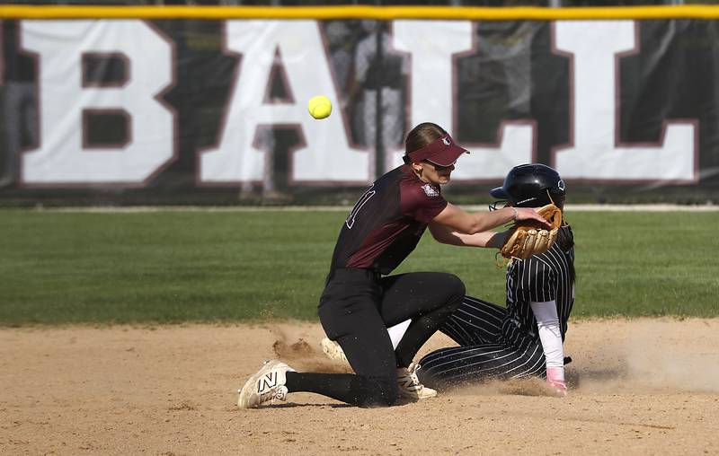 Prairie Ridge's Kylie Carroll tries to field the ball as Crystal Lake Central's Ella Arana slides into second base during a Fox Valley Conference softball game on Monday, April 20, 2026, at Prairie Ridge High School.
