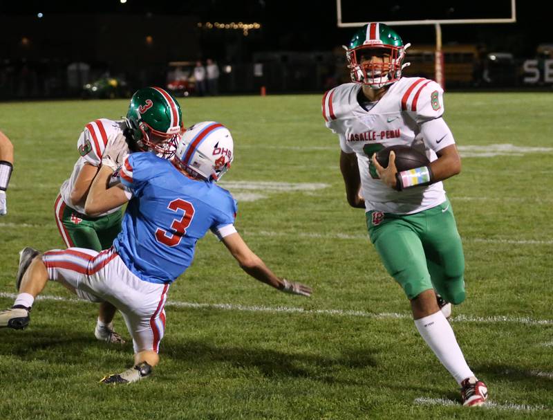 L-P quartetback Marion Persich carries the ball as teammate Michael Hartman blocks Ottawa's Geoge Shumway on Friday, Oct. 4, 2024 at King Field.