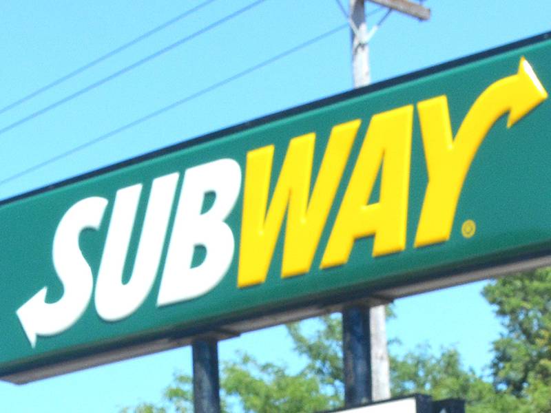 New manager Jenny Dolph, in front of the Greenfield Subway store sign, 212 SE Kent St.