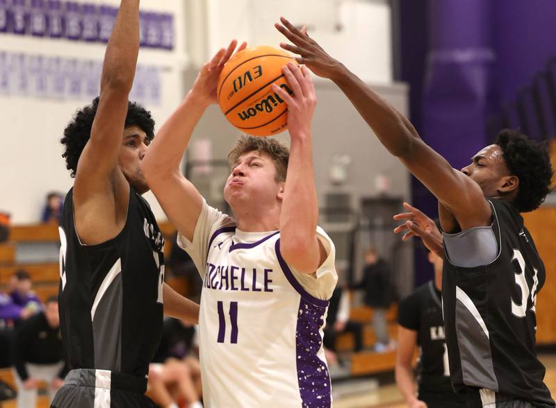 Rochelle's Brody Bruns goes to the basket between two Kaneland defenders Tuesday, Feb. 3, 2026, during their game at Rochelle High School.