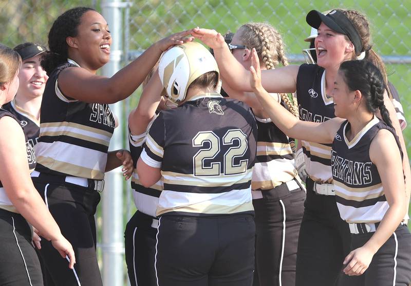 Sycamore's Chelsea Born is congratulated by her teammates after homering during their game against Dixon Thursday, May 12, 2022, at Sycamore High School.