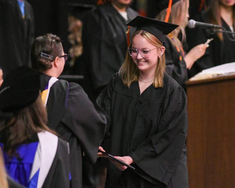 DeKalb High School senior Bella Barker accepts her diploma during the Class of 2023 Commencement ceremony at Northern Illinois University's Convocation Center, 1525 W. Lincoln Highway in DeKalb Saturday, May 27, 2023.