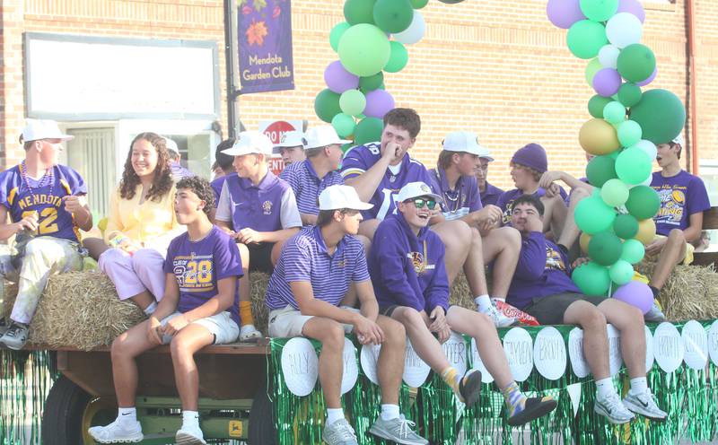 Members of the Mendota High School golf teams ride down Indiana Avenue during the homecoming parade on Friday, Oct. 3, 2025