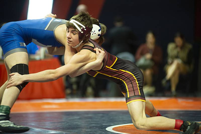 Emmett Nelson of Richmond-Burton reaches for Auburn's Anthony Ruzic during the 1A 113lb finals match at the IHSA state wrestling meet on Saturday, Feb. 19, 2022.