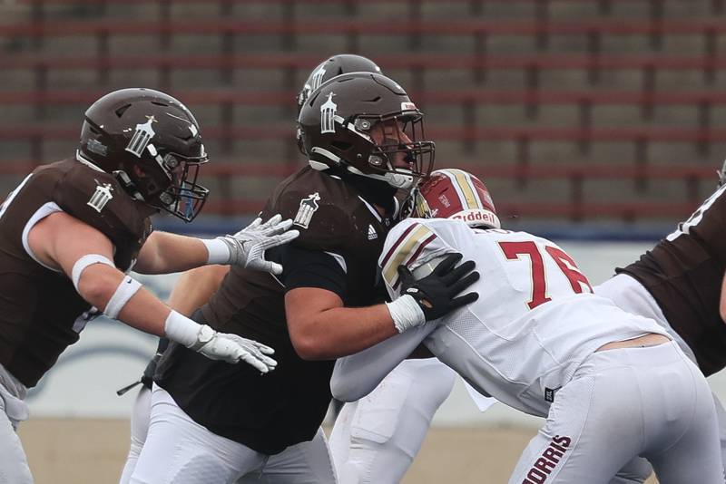 Joliet Catholic’s Cam Juricich blocks a Morris defender in the Class 5A semifinal on Saturday, Nov. 23, 2024.
