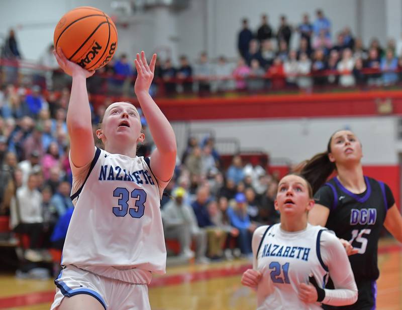 Nazareth’s Molly Moore lays the ball up as teammate Lyla Shelton (21) and Downers Grove North’s Adysen Fanta (15) watch during the Class 4A Hinsdale Central Sectional final game on February 26, 2026 at Hinsdale Central High School in Hinsdale.
