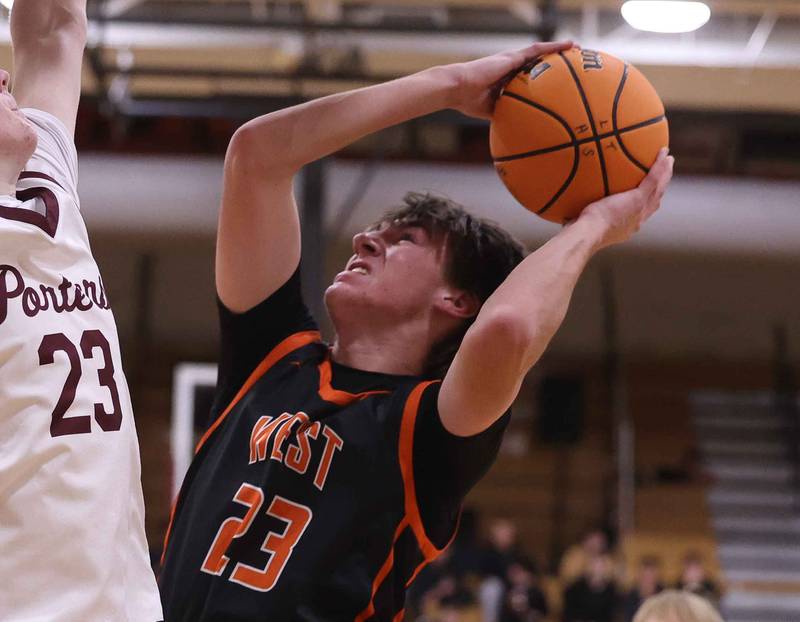 Lincoln-Way West’s Wyatt Carlson takes the contested shot against Lockport on Friday, Dec. 6, 2024 in Lockport.