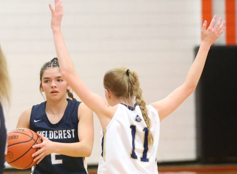 Fieldcrest's Pru Mangan looks to pass the ball around Marquette's Keely Nelson during the Integrated Seed Lady falcon Basketball Classic tournament on Monday, Nov. 13, 2023 at Flanagan High School. s