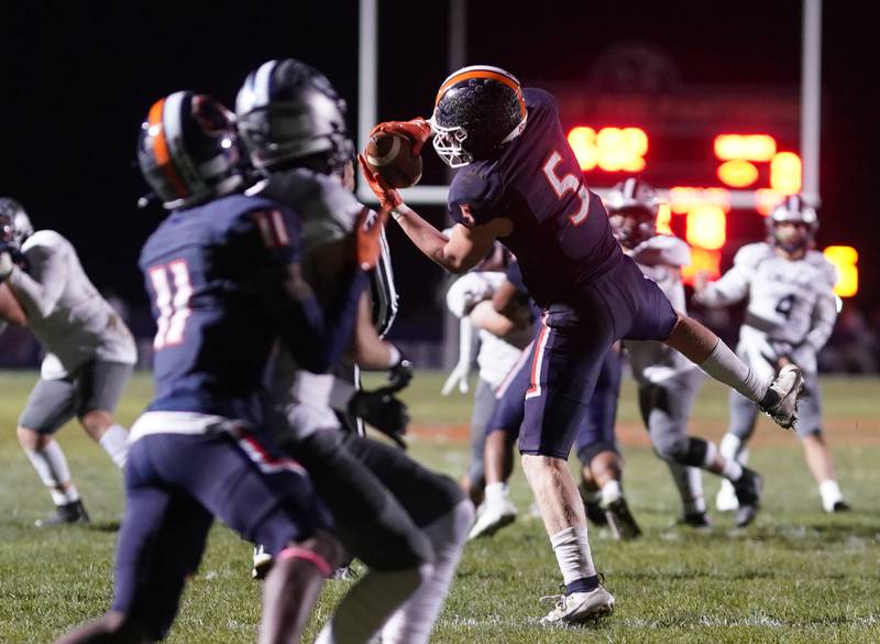 Oswego’s Carson Cooney (5) intercepts a pass against Oswego East during a football game at Oswego High School on Friday, Oct. 20, 2023.