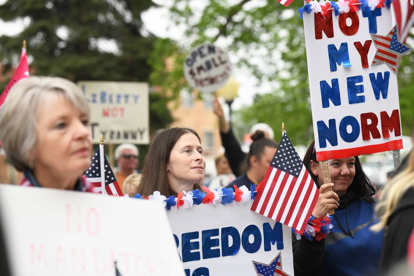 Protesters hold signs as they listen to speakers on May 21, 2020, at the Kankakee County Courthouse during a protest of Gov. J.B. Pritzker’s "stay at home" order.