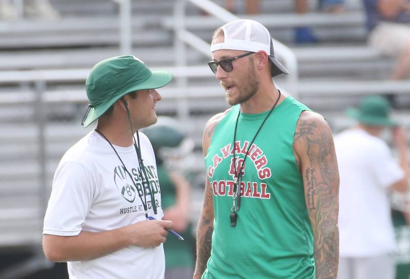 St. Bede head football coach Jack Brady and L-P head football coach JJ Raffelson converse during a joint practice on Monday July 21, 2025 at Howard Fellows Stadium.
