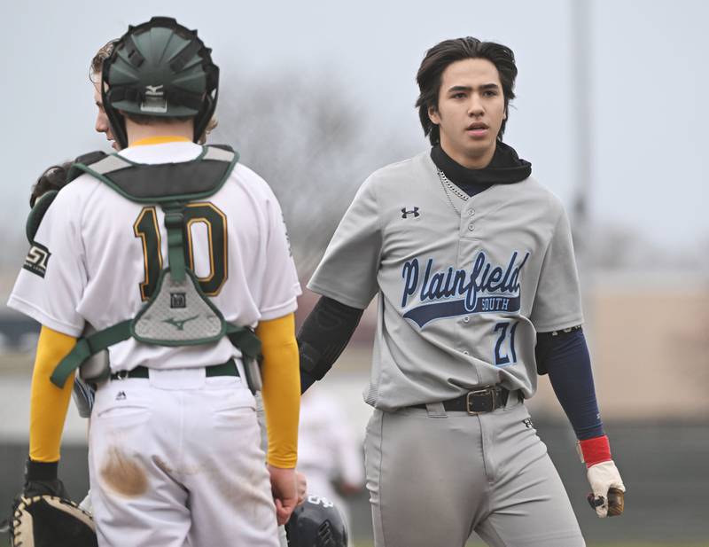 Plainfield South’s Blake Pommachannom crosses the plate with a three-run home run as Elk Grove catcher Nathan Dean watches in a baseball game in Elk Grove Village on Monday, March 25, 2024.