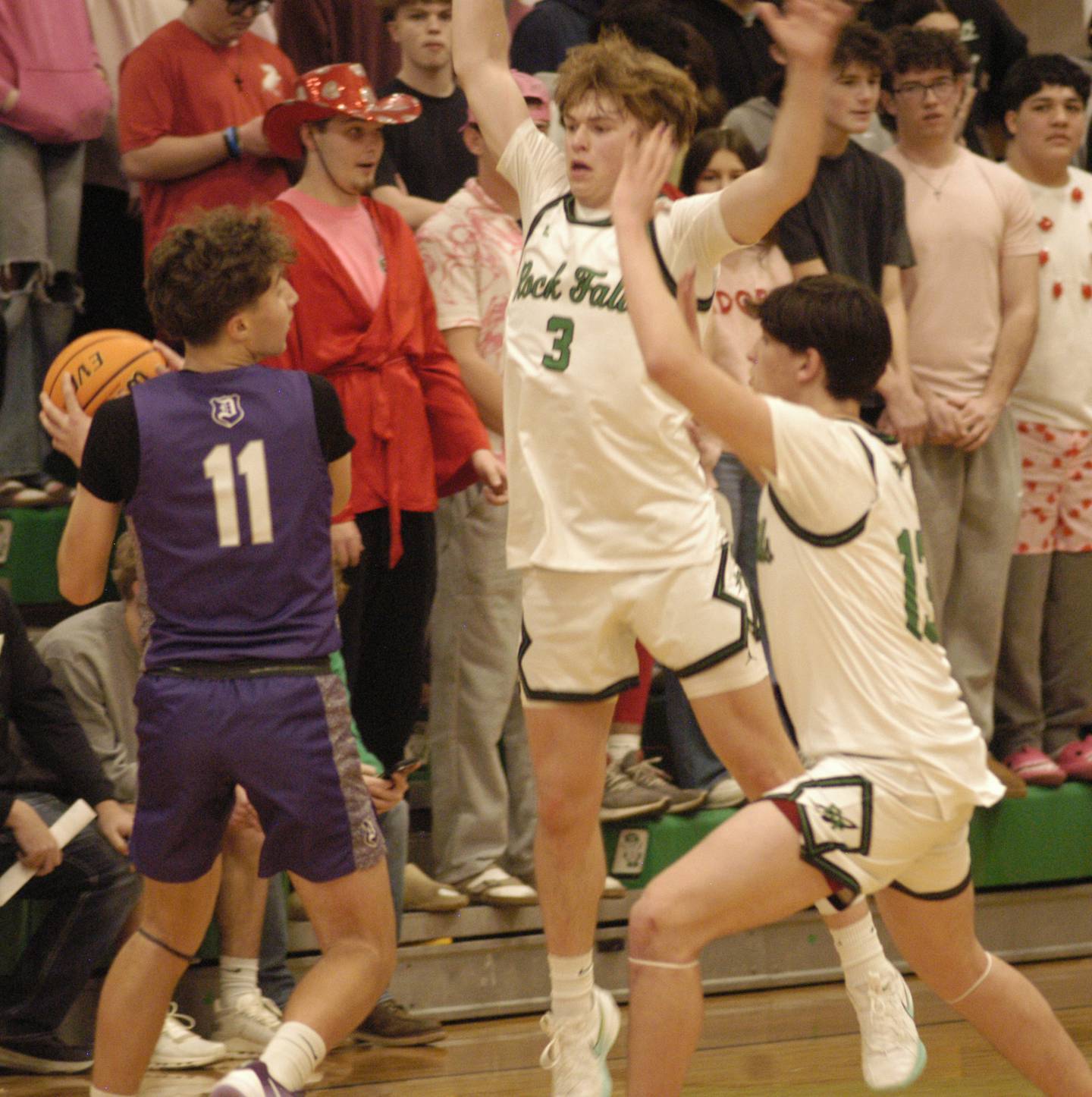 Dixon's Brody Nicklaus runs into Rock Falls defensive players  Cole Heald and  Phillip Griffith, jr. The Rock Falls Rockets hosted the Dixon Dukes in a Conference basketball game. The game was held at Forest Tabor gym in Rock Falls on Friday, February 13, 2026