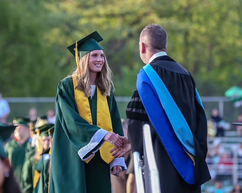 Students receive their diplomas during the Glenbard West High School graduation ceremony. May 19, 2022