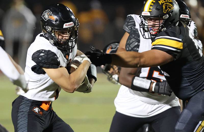 DeKalb's Talen Tate tries to get by Metea Valley's Brady Jones during their game Friday, Sept 15, 2023, at Metea Valley High School in Aurora.