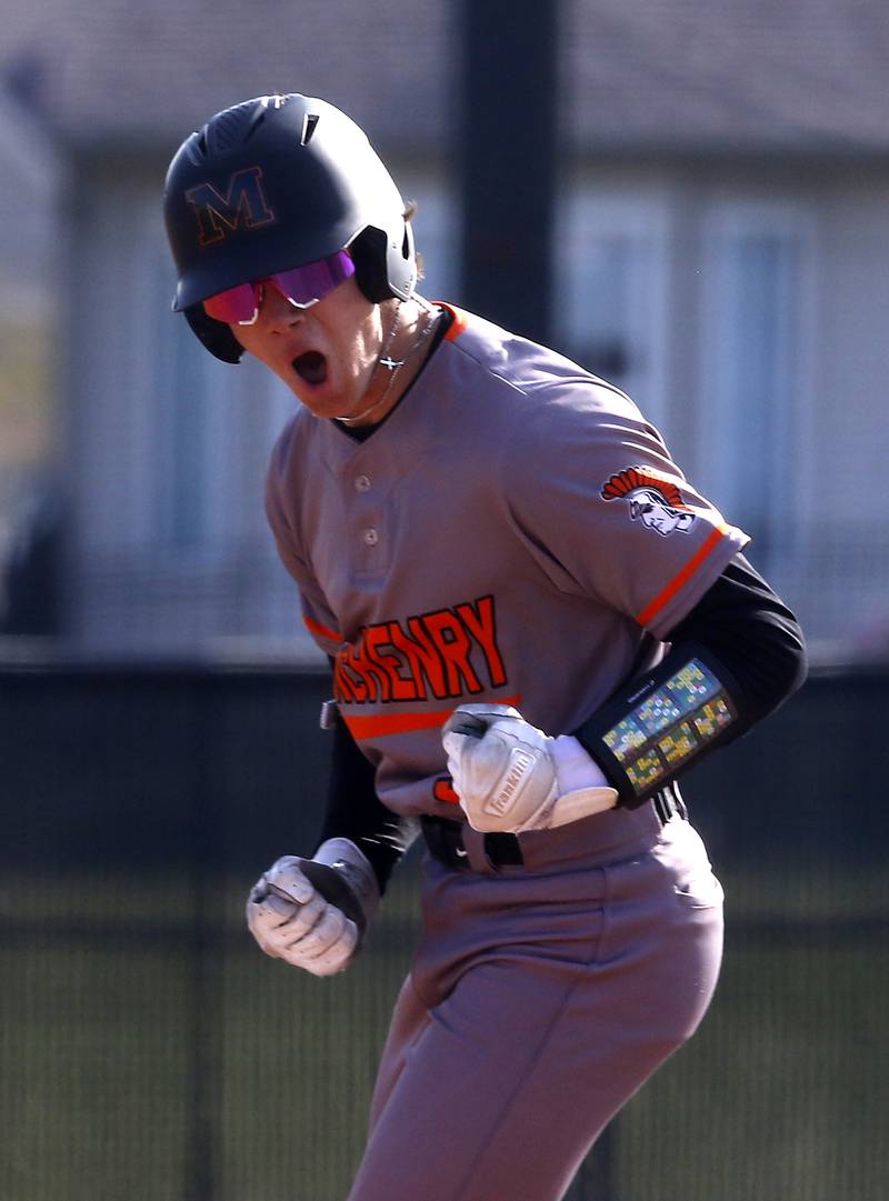 McHenry’s Carver Cohn celebrates his grand slam home run during a Fox Valley Conference baseball game against Huntley on Friday, April 11, 2025, at Huntley High School.