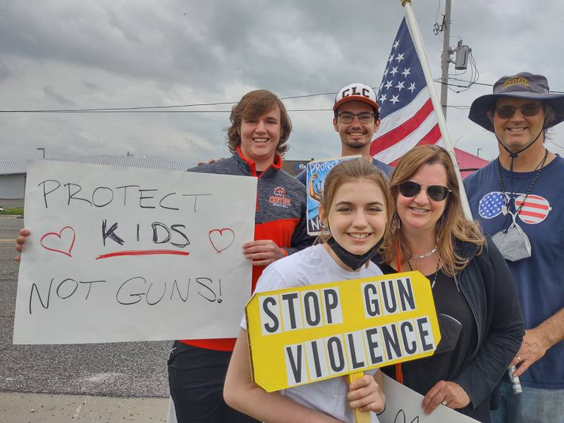From left to right: Aidan Doak, Kevin Gorman, Julia Doak, Betty Doak and Owen Doak line Route 14 along with dozens of other McHenry County and Crystal Lake residents, including teachers, parents, local officials, and kids, Saturday afternoon at a March For Our Lives rally to protest inaction on gun safety in the wake of the Uvalde massacre.