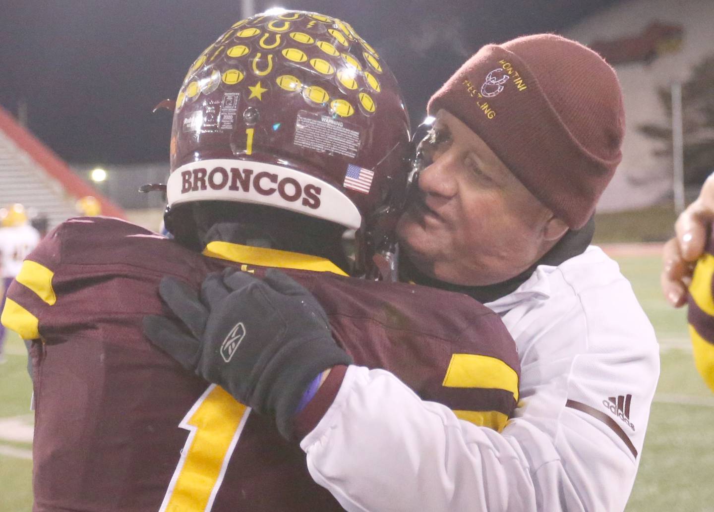 Montini Catholic head coach Mike Bukovsky hugs player Santino Florio after winning  the Class 3A State football championship on Friday, Nov. 29, 2024 at Hancock Stadium in Normal.