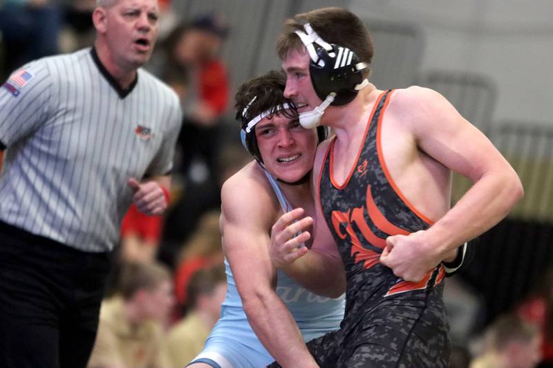 Marian’ Central's Nic Astacio, left, battles Washington’s Wyatt Leman, right, at 175 pounds in varsity boys wrestling on Thursday, Feb. 5, 2026, at Sycamore High School in Sycamore.