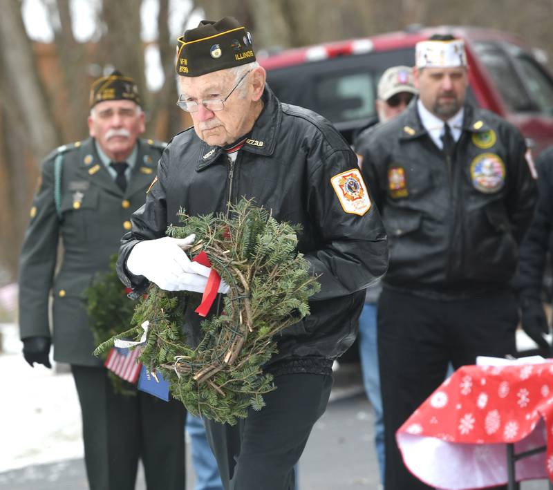 Stan Eden of Oregon, a Korean war veteran, lays a wreath in honor of the Merchant Marines, at Daysville Cemetery on Dec. 17 during the Wreaths Across America project. Wreaths were then placed on veterans' graves by other volunters and veterans.