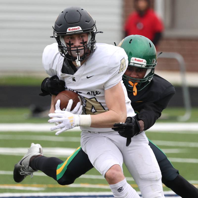 Sycamore's Aidan Wyzard tries to break the tackle of Westinghouse's Elijah Carter Saturday, Nov. 9, 2024 during their Class 5A second-round playoff game at Knute Rockne Stadium in Chicago.