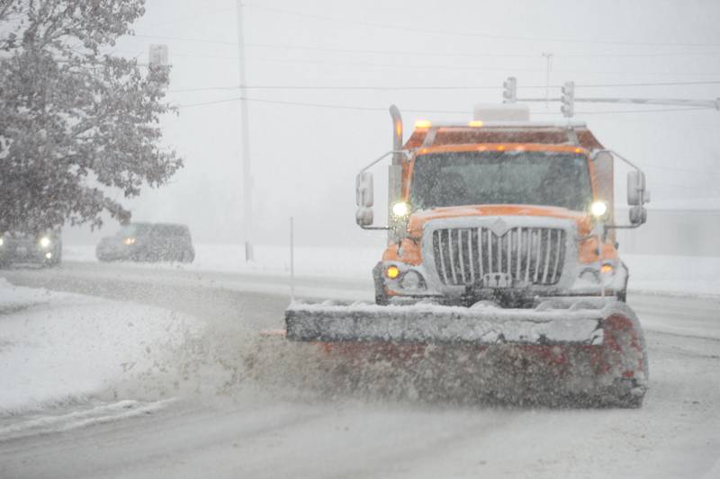 An Illinois Department of Transportation snow plow makes it way along state Route 2 into Oregon on Tuesday, Jan. 9, 2024. Visibility on rural roads was starting to decrease after heavy wet snow fell across the region. More snow was forecast to fall throughout the evening.