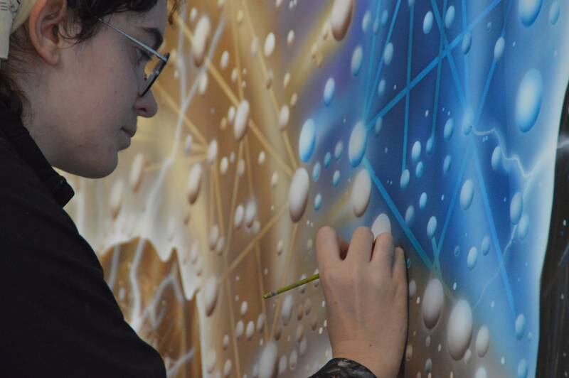 Once the background weaving the past and modern characters together was completed, artist Morgan Phillips began filling in details. The mural celebrates the college’s progress from its creation as LPO Junior College to the modern campus.