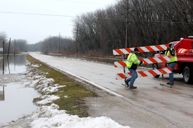 La Salle County Highway Department officials move barricades to close Dee Bennett Road on Friday, Jan. 26, 2024 near the La Salle County Nursing Home. La Salle County Highway Department has closed Dee Bennett Road from the intersection of North 2803rd Road and Dee Bennett west to Utica.