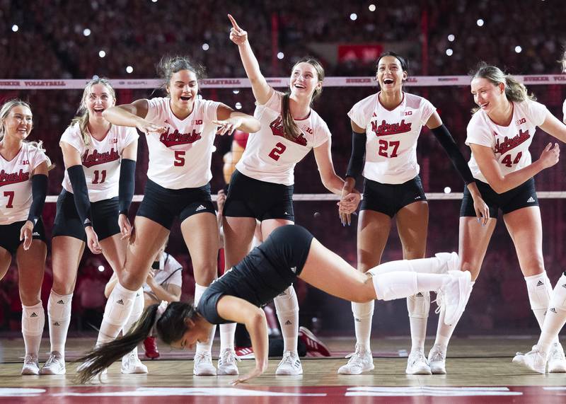 Nebraska's Lexi Rodriguez, bottom, performs the worm as her teammates cheer her on following a college volleyball match against Omaha at Memorial Stadium, Wednesday, Aug. 30, 2023, in Lincoln, Neb.