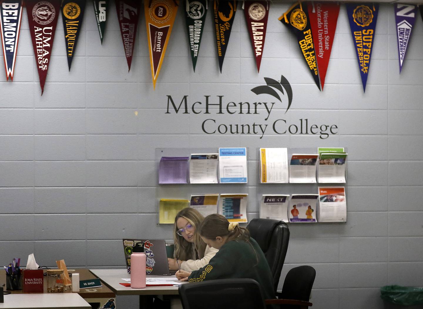 Hailey Baker, the college and career advisor at Crystal Lake South High School, helps senior Meg Norten fill out a scholarship application Thursday, Jan. 26, 2023, at the school in Crystal Lake. This year's senior class is made up of students who began their high school careers dealing with COVID-19.