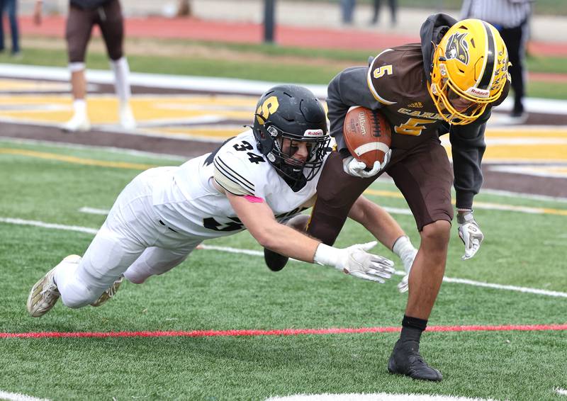 Sycamore's Joey Puleo brings down Carmel's Jarren Black during their Class 5A second round playoff game Saturday, Nov. 5, 2022, at Carmel Catholic High School in Mundelein.