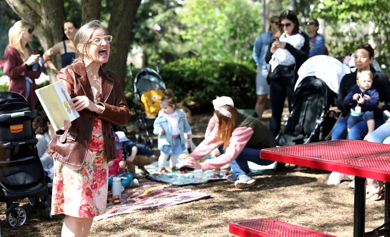 Sarah Burnside, early literacy librarian at the the Helen Plum Library, reads a story as part of Lilac Time at Lilacia Park in Lombard.