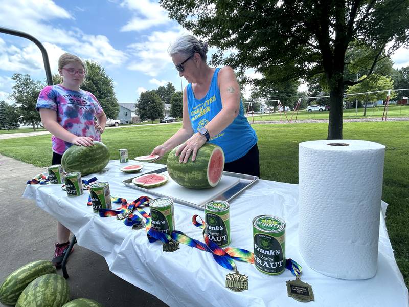 Sauerkraut Days' Committee Member Kathy Bickford slices watermelon for the watermelon eating contest at at Forreston's Sauerkraut Days on Saturday, Aug. 3, 2024. Winners of each age division were awarded a medal and a can of Frank's Sauerkraut.