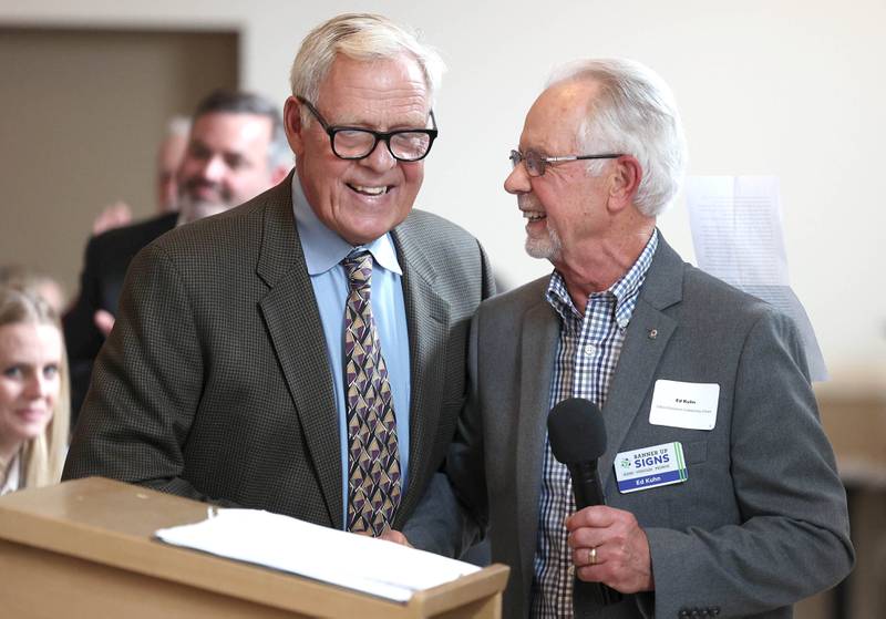 Ed Kuhn (right) is congratulated as he comes up to accept the Clifford Danielson Outstanding Citizen Award during the 107th Annual Sycamore Chamber of Commerce Meeting Thursday, March 7, 2023, in Memorial Hall at St. Mary's Catholic Church in Sycamore.