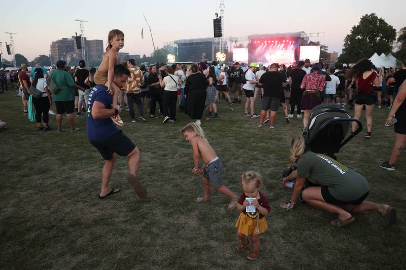 The Rohde family dances to the music of Sum 41 at Riot Fest on Friday, Sept. 20, 2024 in Chicago.