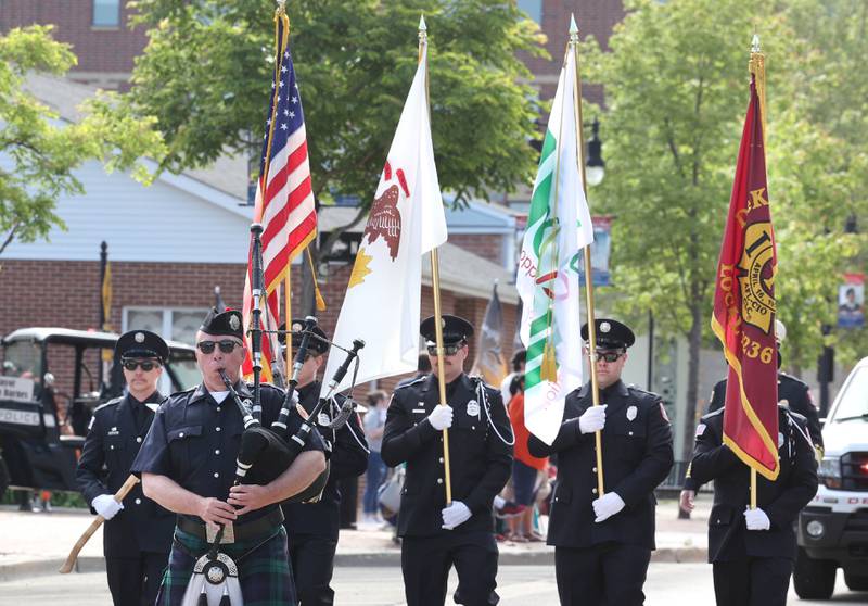 A Bagpiper along with members of the DeKalb Fire Department march Monday, May 29, 2023, in the DeKalb Memorial Day parade.