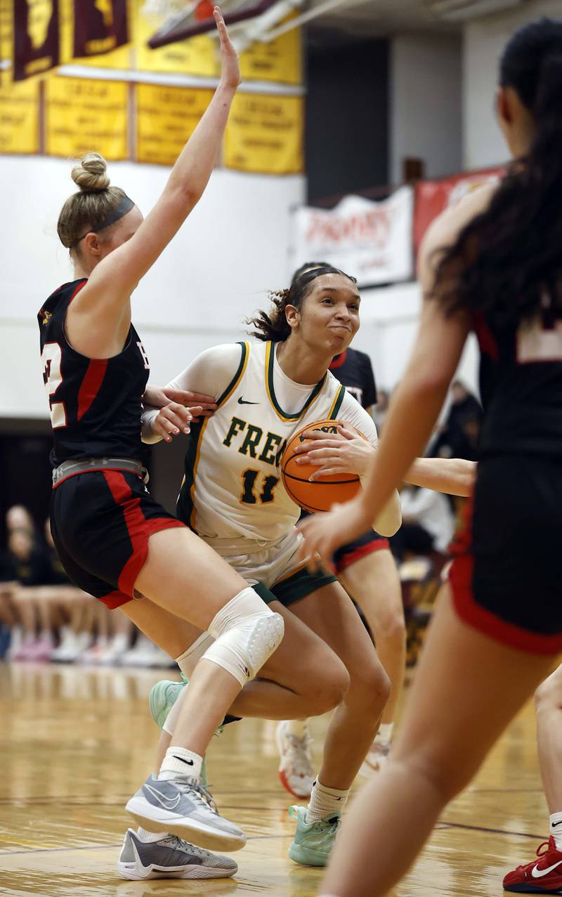 Fremd’s Coco Urlacher (11) drives to the hoop past Benet Academy's Bridget Rifenburg (22) during the Montini girls basketball Christmas tournament Saturday, Dec. 28, 2024 in Lombard.
